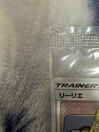 Bandai Pokemon Card Lele Promo from Japan import sealed in a loader, displayed on a dark background