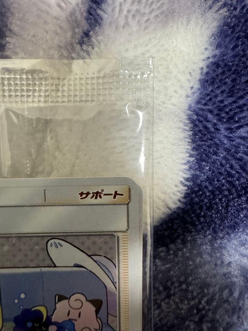 Bandai Pokemon Card Lele Promo from Japan import sealed in a loader, displayed on a dark background