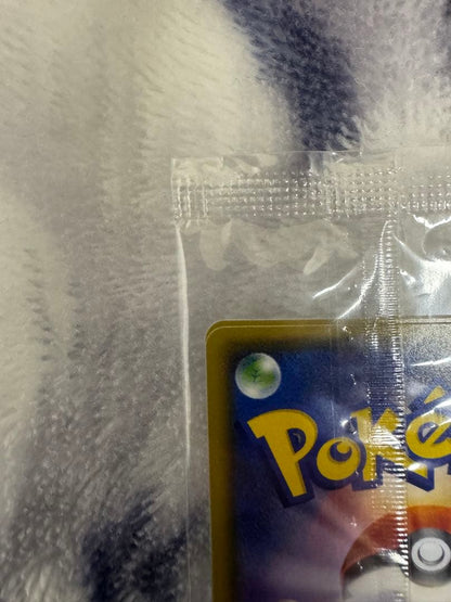 Bandai Pokemon Card Lele Promo from Japan import sealed in a loader, displayed on a dark background