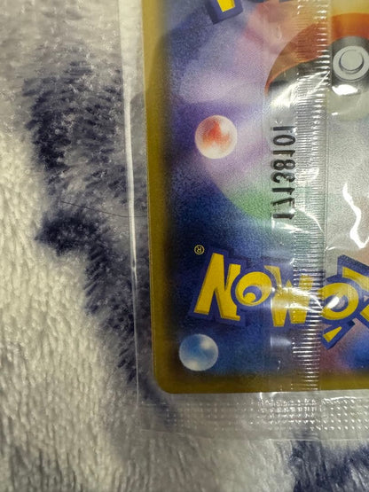 Bandai Pokemon Card Lele Promo from Japan import sealed in a loader, displayed on a dark background