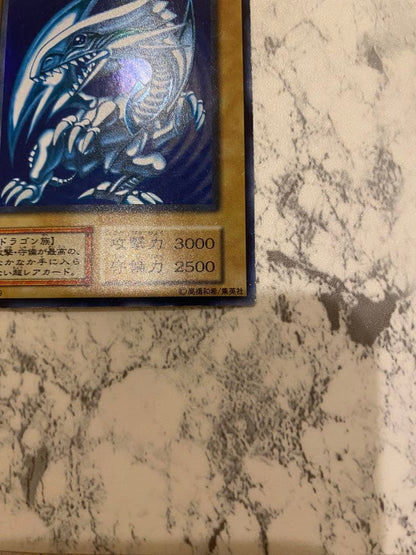 Yu-Gi-Oh! Blue-Eyes White Dragon Initial Edition Monster Card from Duel Monsters series in amateur storage