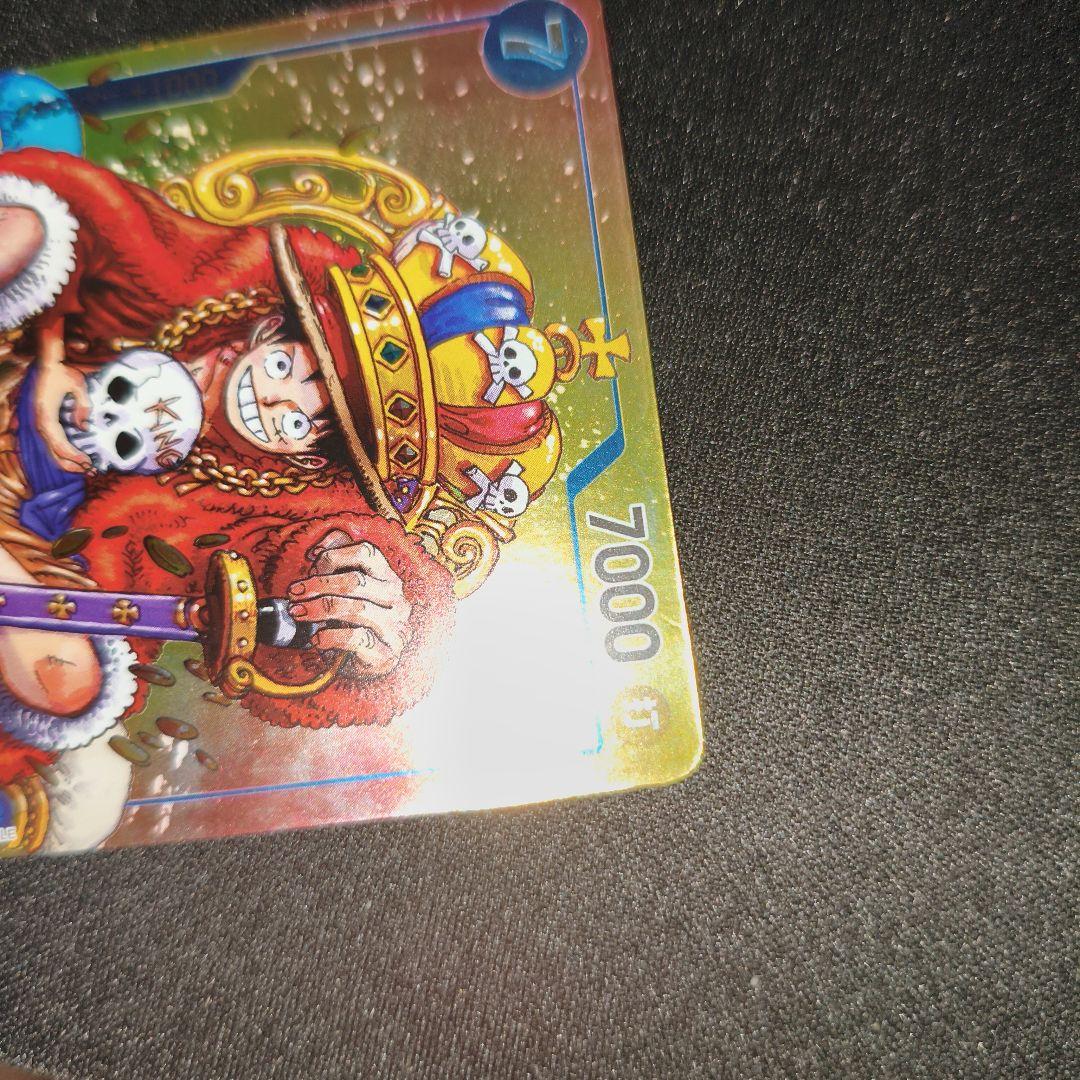 One Piece Monkey D. Luffy P-043 collectible card showing front with minor scratches and paint peeling on back