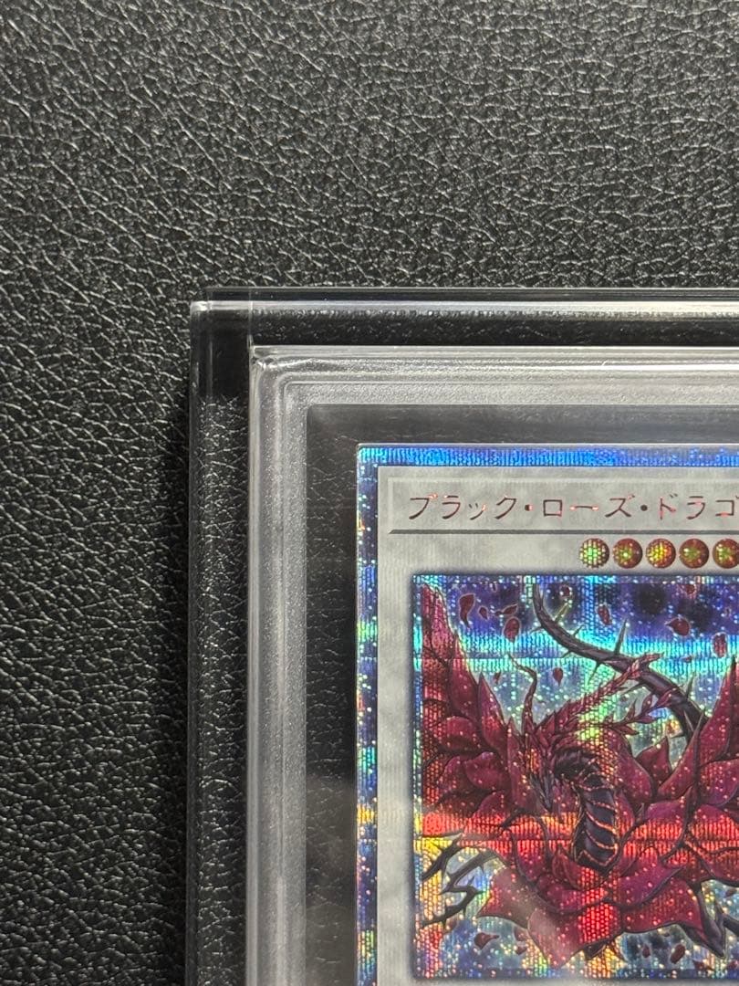 Yugioh Black Rose Dragon 20th ARS10+ card with acrylic case showing front and box with scratches