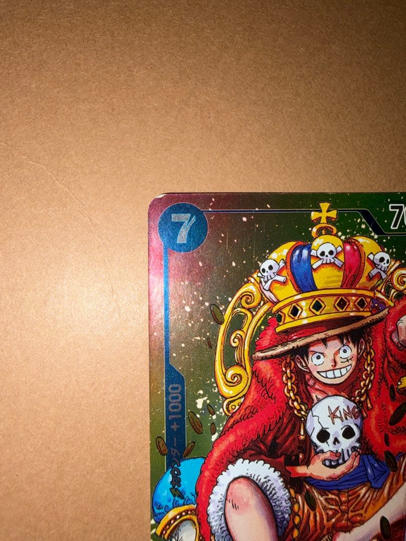 Used Monkey D. Luffy OP05 SR Japanese trading card from One Piece series with visible scratches and stored in case