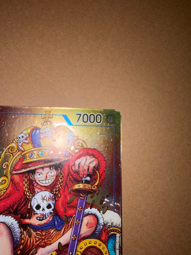 Used Monkey D. Luffy OP05 SR Japanese trading card from One Piece series with visible scratches and stored in case