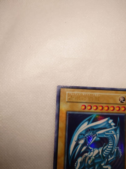 Blue-Eyes White Dragon Initial Ultra Rare Yu-Gi-Oh trading card with minor wear, Japan import
