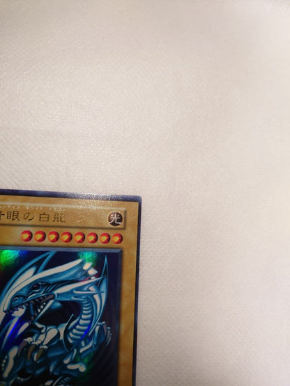 Blue-Eyes White Dragon Initial Ultra Rare Yu-Gi-Oh trading card with minor wear, Japan import