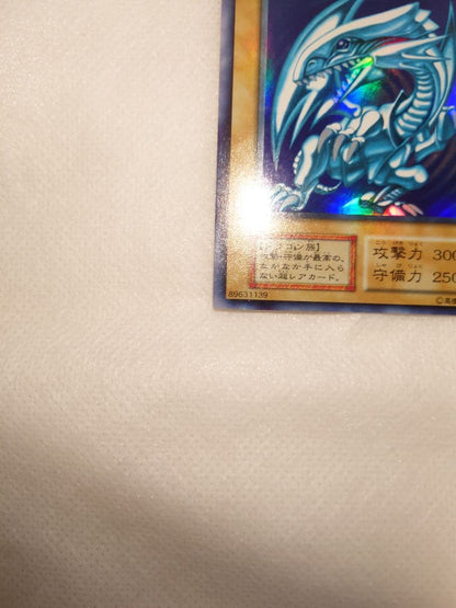 Blue-Eyes White Dragon Initial Ultra Rare Yu-Gi-Oh trading card with minor wear, Japan import