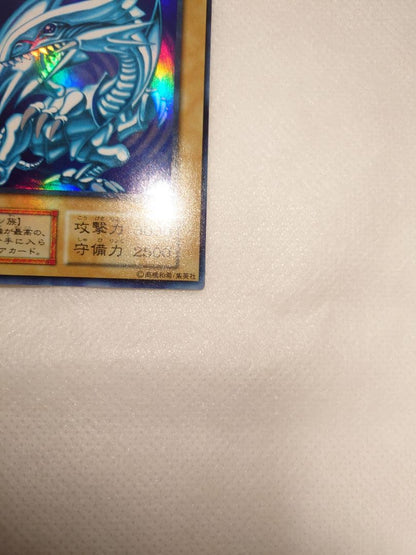 Blue-Eyes White Dragon Initial Ultra Rare Yu-Gi-Oh trading card with minor wear, Japan import