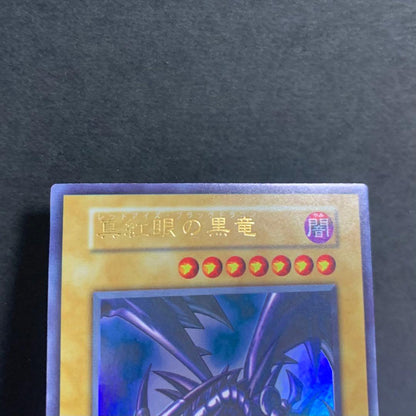Used Yugioh Red-Eyes Black Dragon Ultra Rare card from initial Japanese set with good centering and condition
