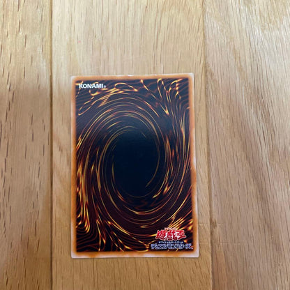 Yu-Gi-Oh Blue-Eyes Ultimate Dragon Ultra Rare SDX-001 card with visible scratches and chipping