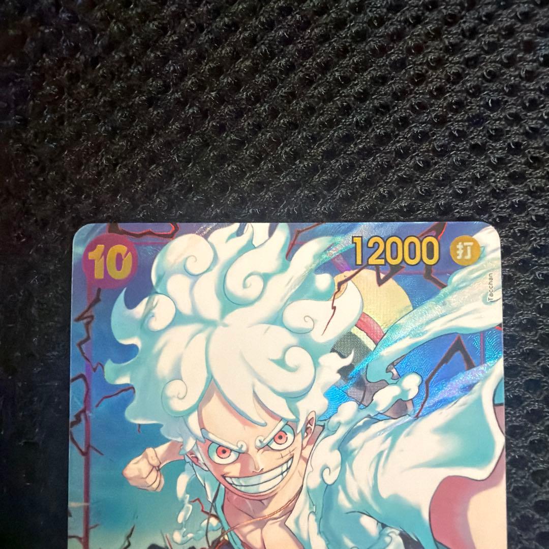 One Piece Monkey D. Luffy SEC Parallel OP05-119 trading card with sleeve and hard case