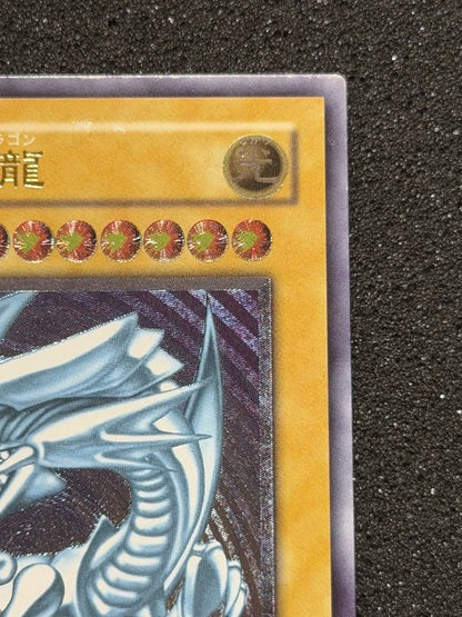 Blue-Eyes White Dragon Ultimate Rare Relief trading card with minor white paint missing on edges