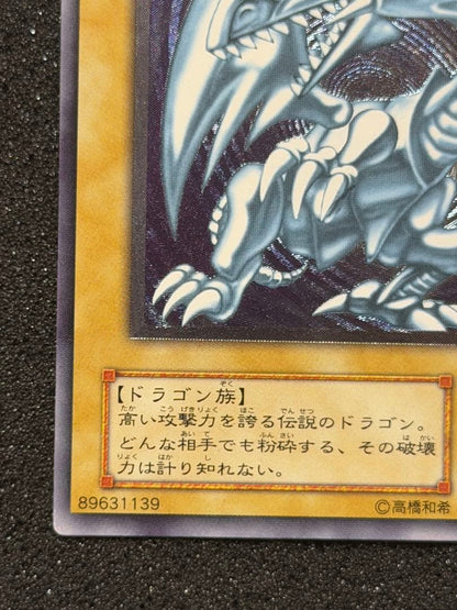 Blue-Eyes White Dragon Ultimate Rare Relief trading card with minor white paint missing on edges