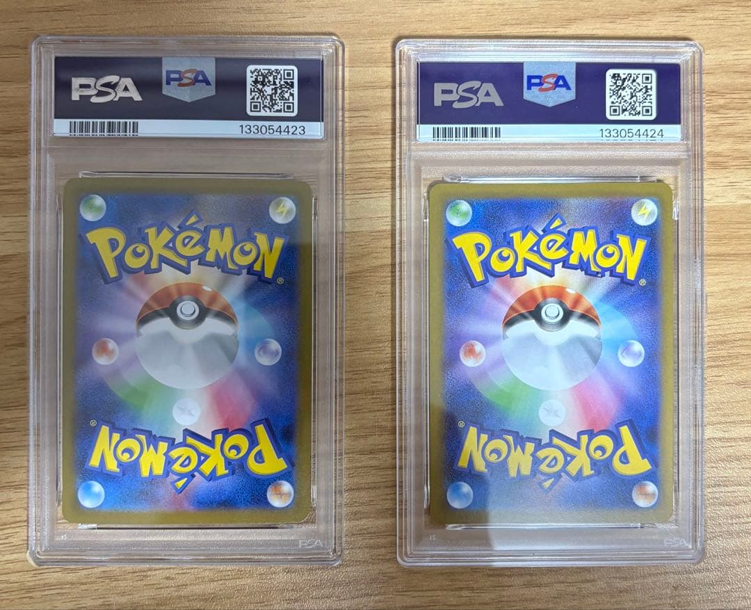 PSA10 graded Pokémon cards featuring Ninfiaex and Boulaxex with serial numbers in a collector set