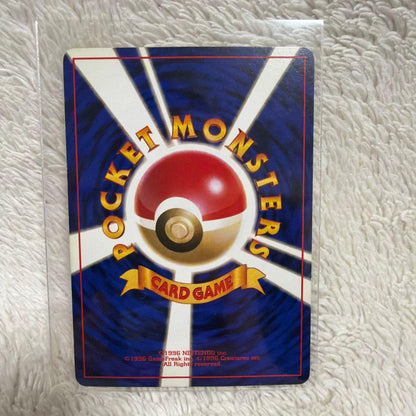 Pokemon Series One Ekans trading card with holo wrap outside illustration in used condition