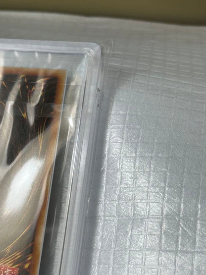 Yugioh Ultra Rare Black Magician Girl PSA Card 8 sealed Japanese import with dirt on adhesive