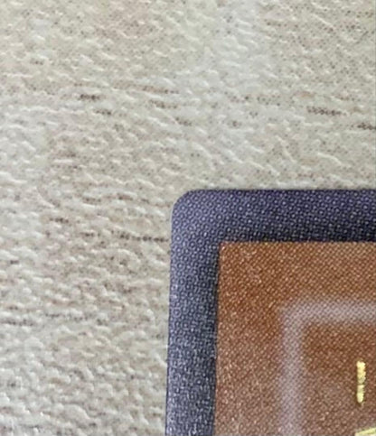 Vintage Yu-Gi-Oh Revolvedragon relief card in retro style stored in a filing system