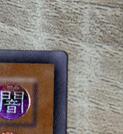 Vintage Yu-Gi-Oh Revolvedragon relief card in retro style stored in a filing system
