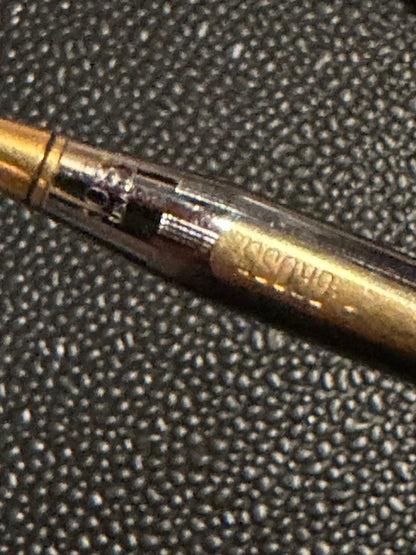 Cross ballpoint pen with silver and gold body, dark blue ink, made in USA, showing signs of use