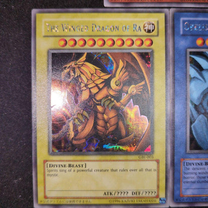 Bandai Yu-Gi-Oh GBI Secret Rare trading cards set featuring Osiris The Sky Dragon, Obelisk The Giant God Soldier, and Ra Winged Dragon of Ra