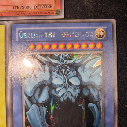 Bandai Yu-Gi-Oh GBI Secret Rare trading cards set featuring Osiris The Sky Dragon, Obelisk The Giant God Soldier, and Ra Winged Dragon of Ra