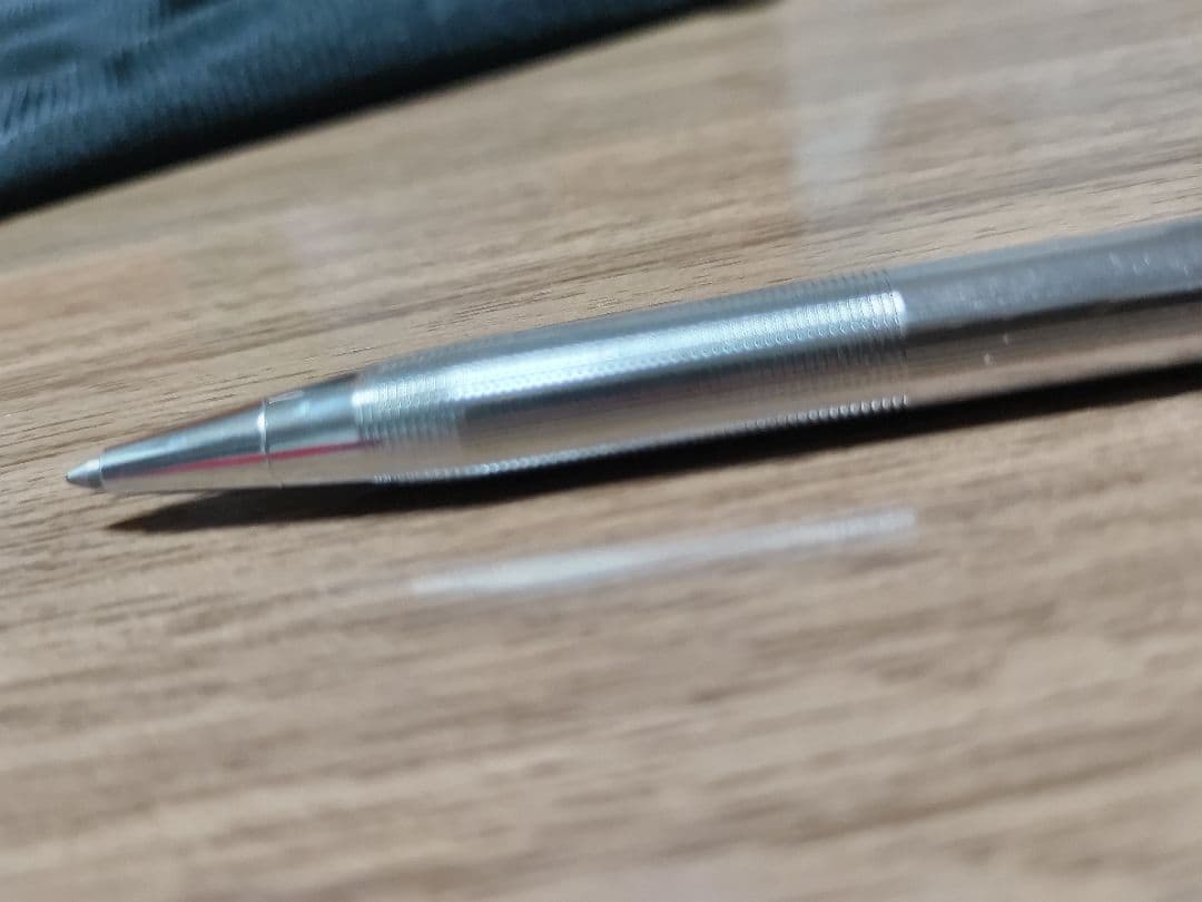 Cross ballpoint pen with silver body and detailed knurled grip, featuring blue ink