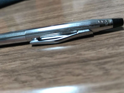 Cross ballpoint pen with silver body and detailed knurled grip, featuring blue ink