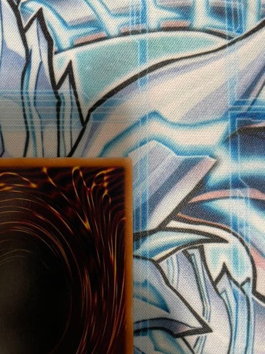 Yugioh Red-Eyes Black Dragon Relief vintage trading card with minor wear, shown in protective sleeve
