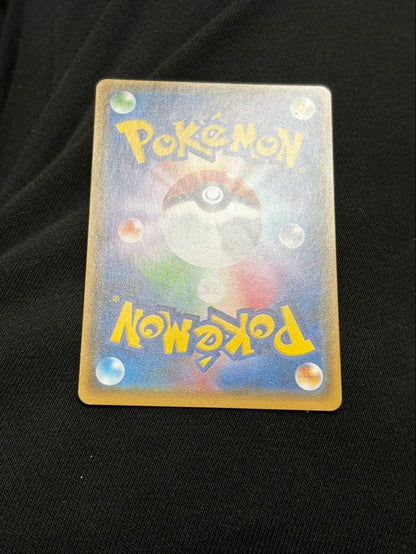 Pokemon promotional card featuring Eevee wearing a poncho with slight crease and small chip