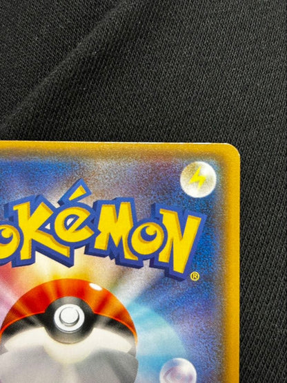 Pokemon promotional card featuring Eevee wearing a poncho with slight crease and small chip