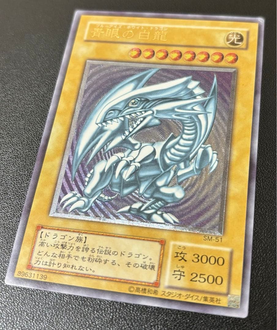Blue-Eyes White Dragon relief card with 3000 attack power showing slight crease in upper right corner