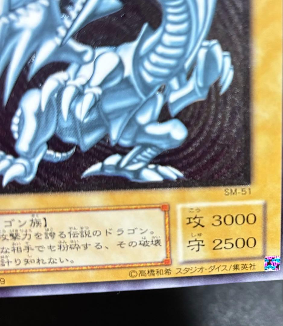 Blue-Eyes White Dragon relief card with 3000 attack power showing slight crease in upper right corner