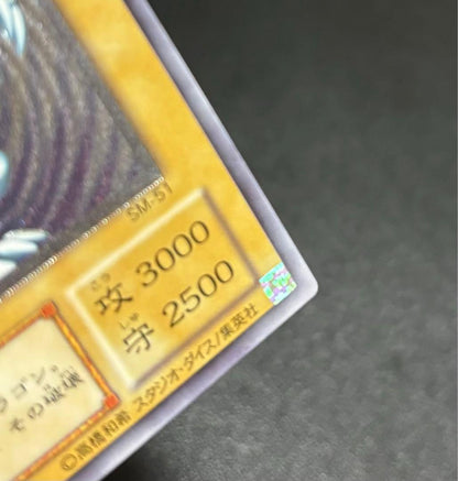 Blue-Eyes White Dragon relief card with 3000 attack power showing slight crease in upper right corner