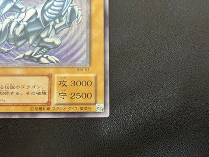 Blue-Eyes White Dragon relief card with 3000 attack power showing slight crease in upper right corner