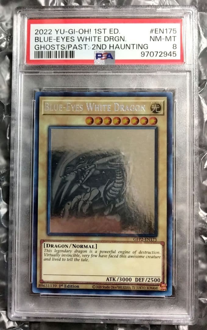 Blue-Eyes White Dragon GFTP English Error Card PSA8 with blacked-out artwork edge and shifted print