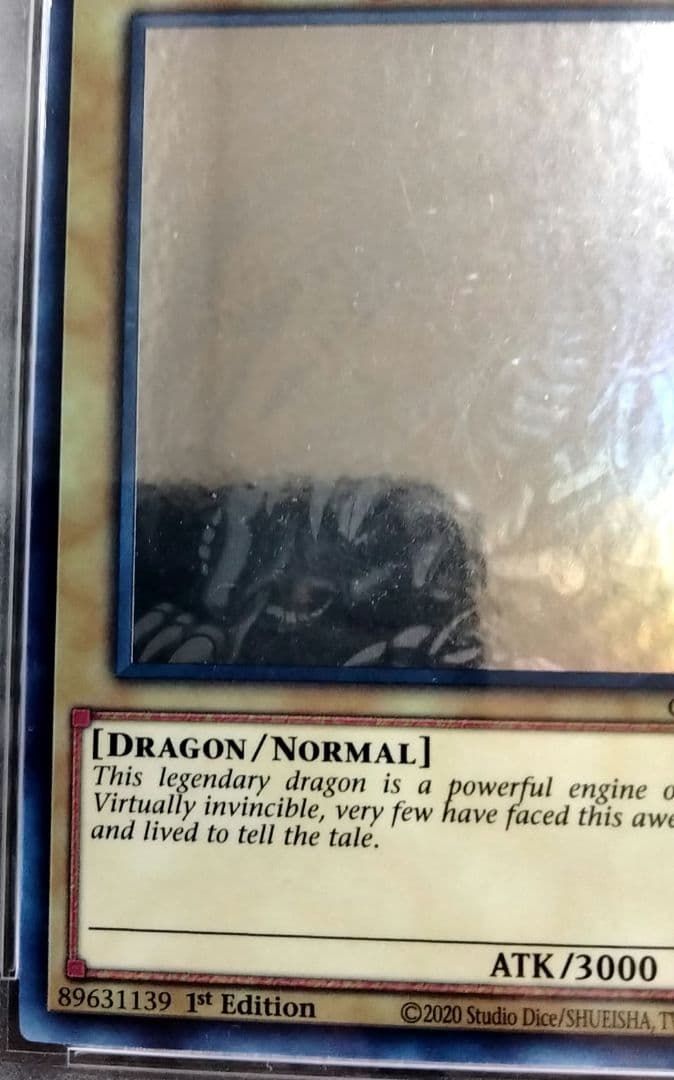 Blue-Eyes White Dragon GFTP English Error Card PSA8 with blacked-out artwork edge and shifted print