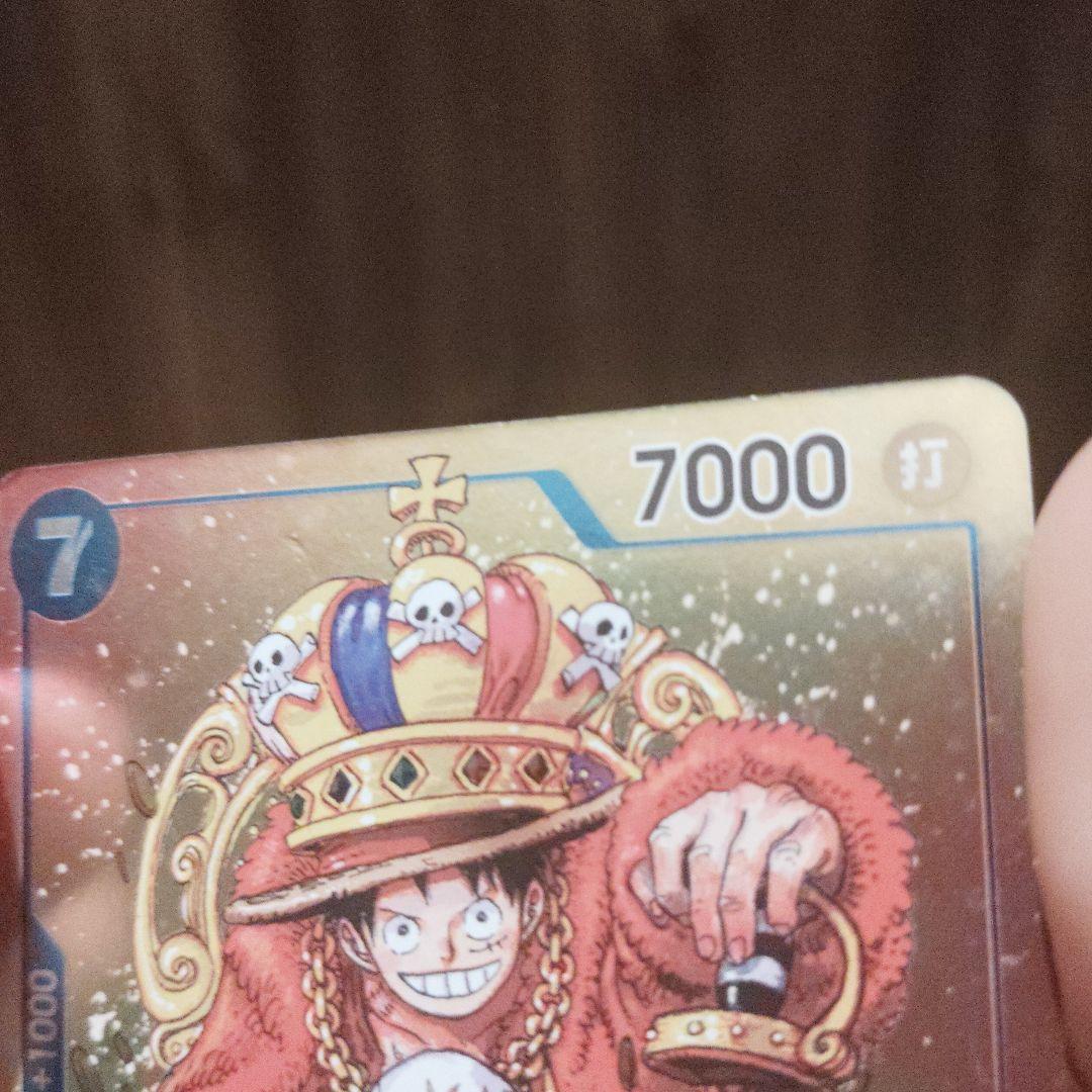 One Piece Monkey D. Luffy character card P-043 wearing a crown with power 7000 and strike attribute