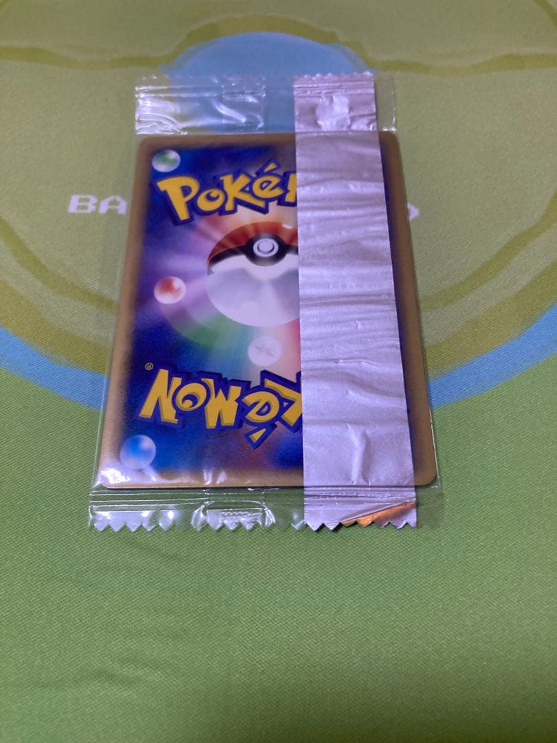 Unopened Meiji Mewtwo Delta Species 107/PCG-P Japanese promo collectible card with visible packaging wrinkles