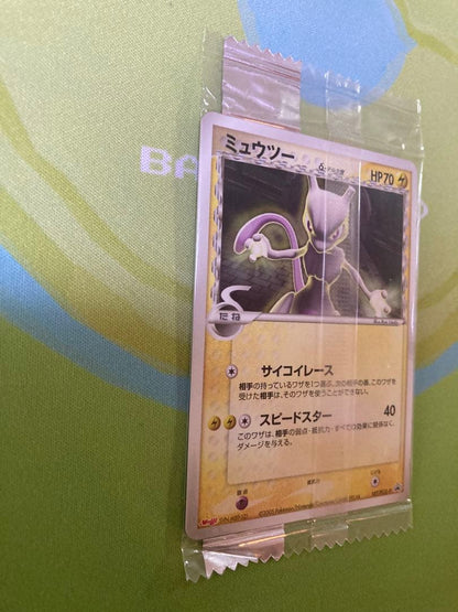 Unopened Meiji Mewtwo Delta Species 107/PCG-P Japanese promo collectible card with visible packaging wrinkles