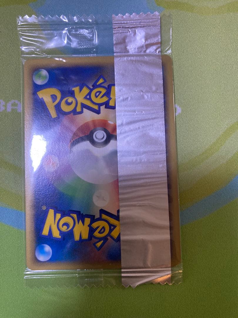 Unopened Meiji Mewtwo Delta Species 107/PCG-P Japanese promo collectible card with visible packaging wrinkles