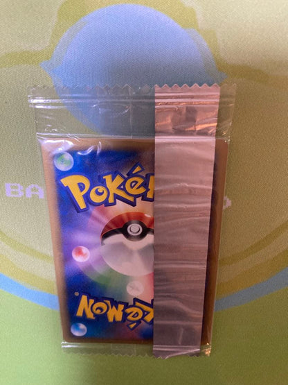 Unopened Meiji Mewtwo Delta Species 107/PCG-P Japanese promo collectible card with visible packaging wrinkles