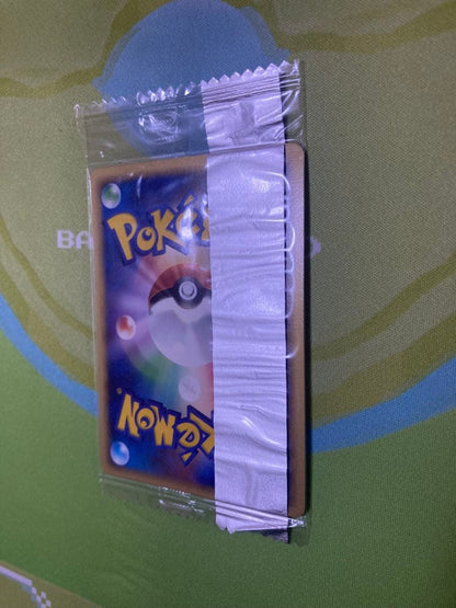 Unopened Meiji Mewtwo Delta Species 107/PCG-P Japanese promo collectible card with visible packaging wrinkles