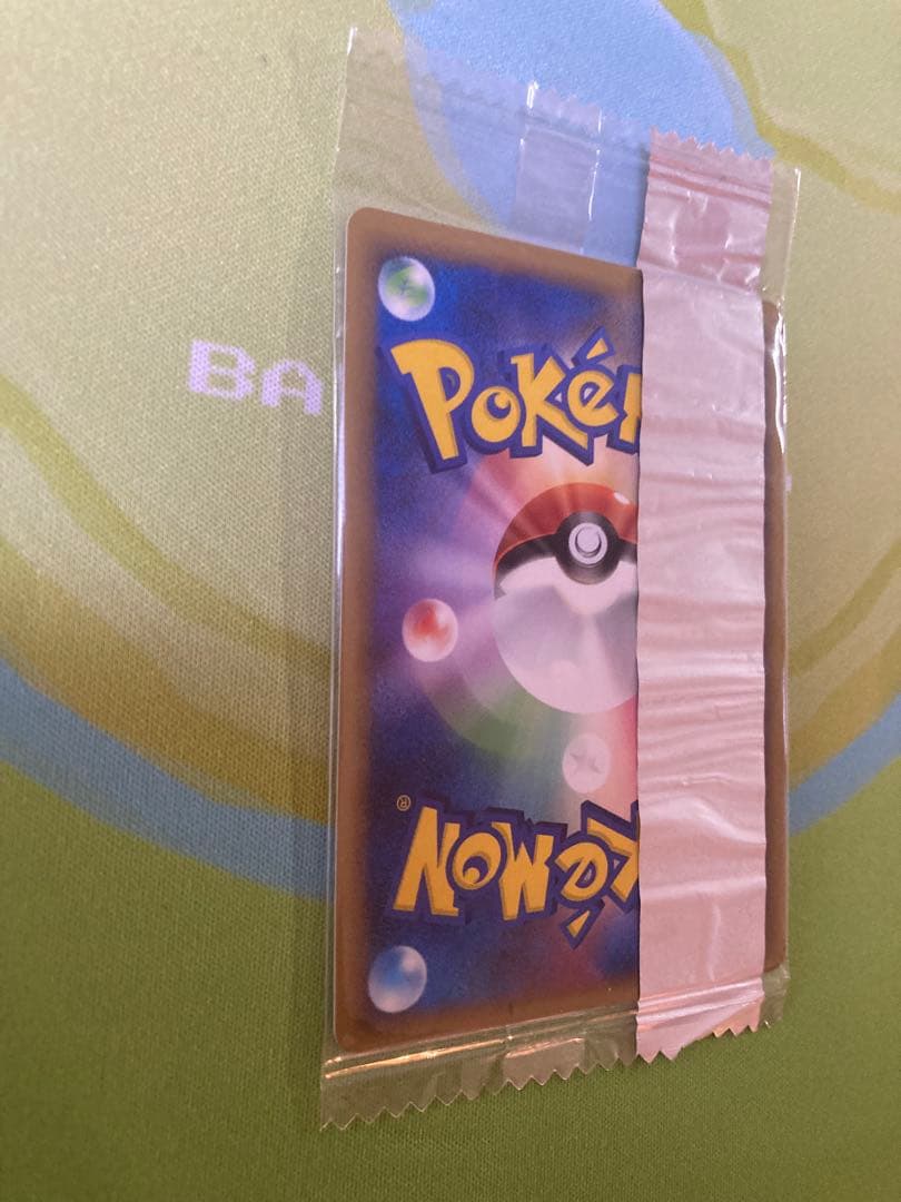 Unopened Meiji Mewtwo Delta Species 107/PCG-P Japanese promo collectible card with visible packaging wrinkles
