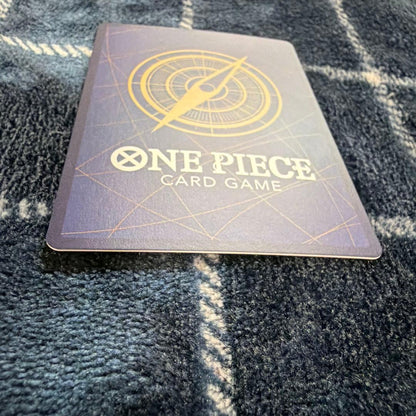Used One Piece Card Game Nami R OP06-101 promotional card showing minor scratches and stored in protective sleeve