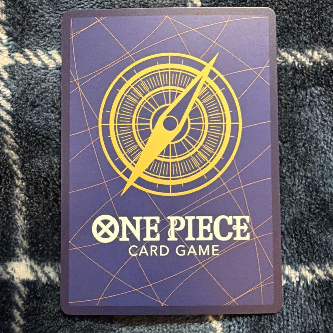 Used One Piece Card Game Nami R OP06-101 promotional card showing minor scratches and stored in protective sleeve