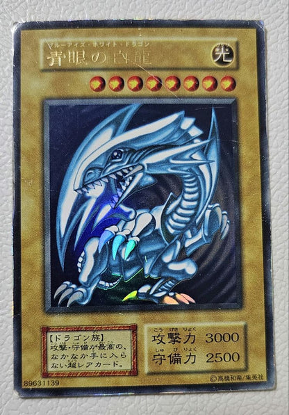 Yugioh Blue-Eyes White Dragon Ultra Rare card from 1999 Starter Box showing scratches and edge wear