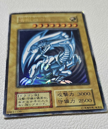 Yugioh Blue-Eyes White Dragon Ultra Rare card from 1999 Starter Box showing scratches and edge wear
