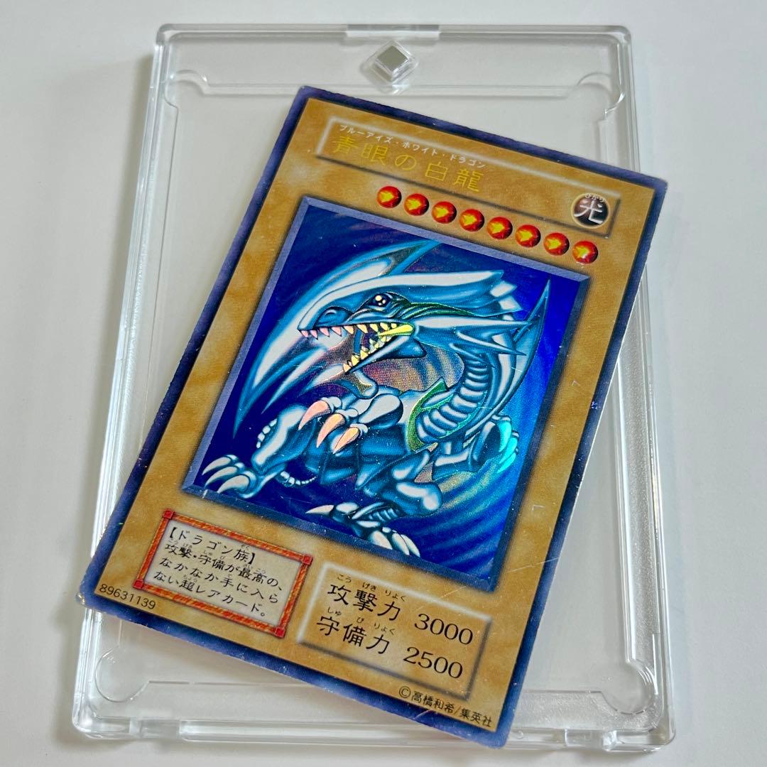 Blue-Eyes White Dragon ultra rare trading card from early Japanese starter box collection in protective sleeve and loader