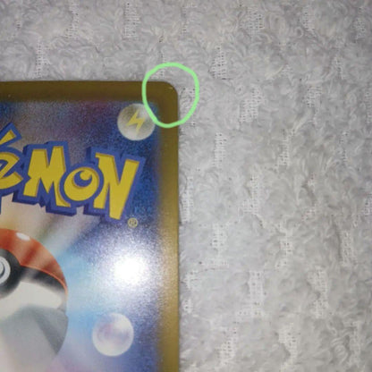 Classic Pokemon Charizard card with clean surface and small chip on upper right corner of the back